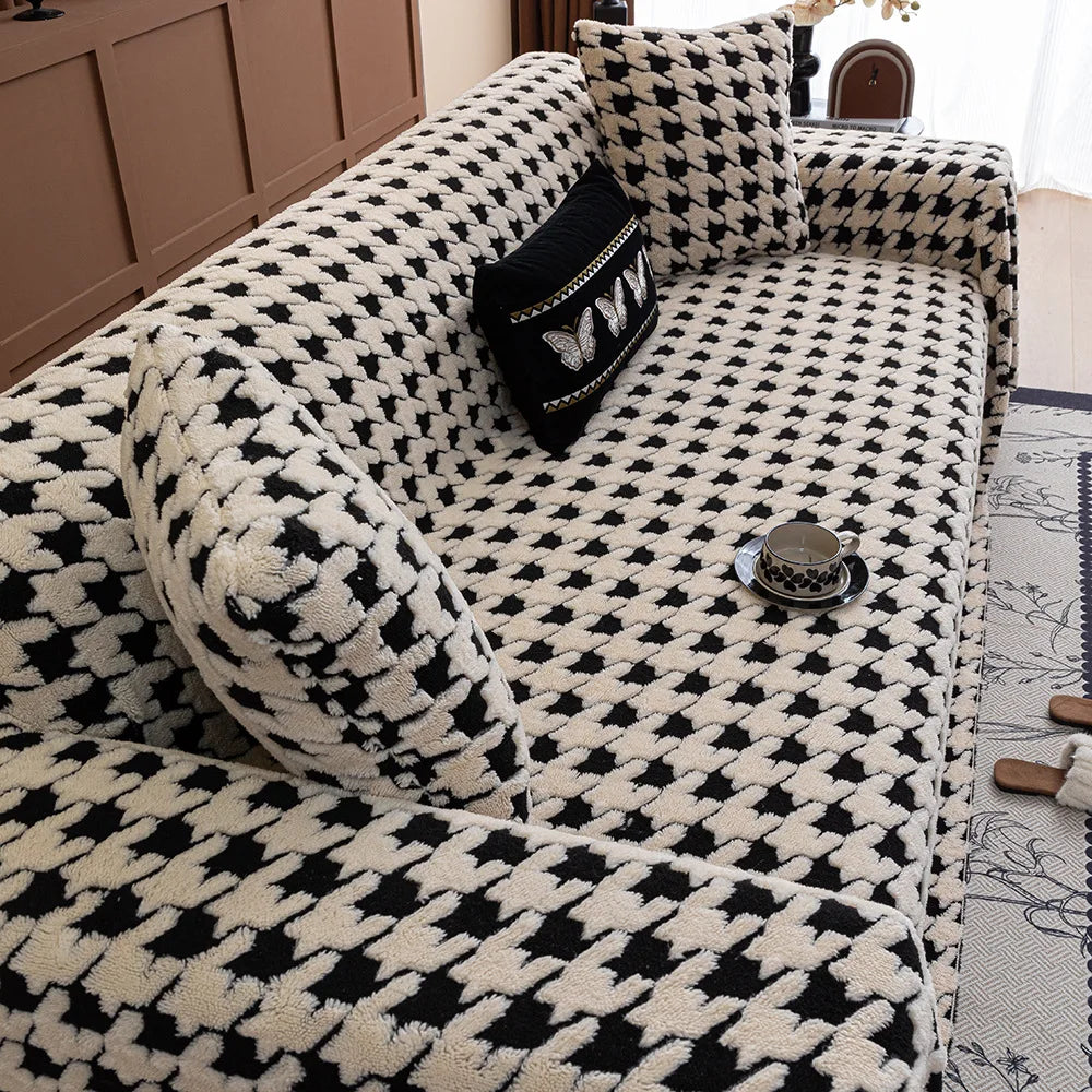 Black and white patterned sofa with decorative pillows in a living room setting.