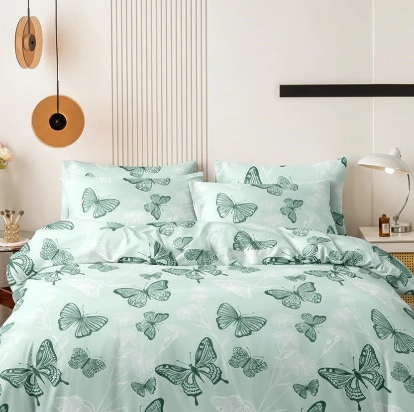 Sage-green butterfly-print duvet cover set with matching pillowcases in a styled bedroom.