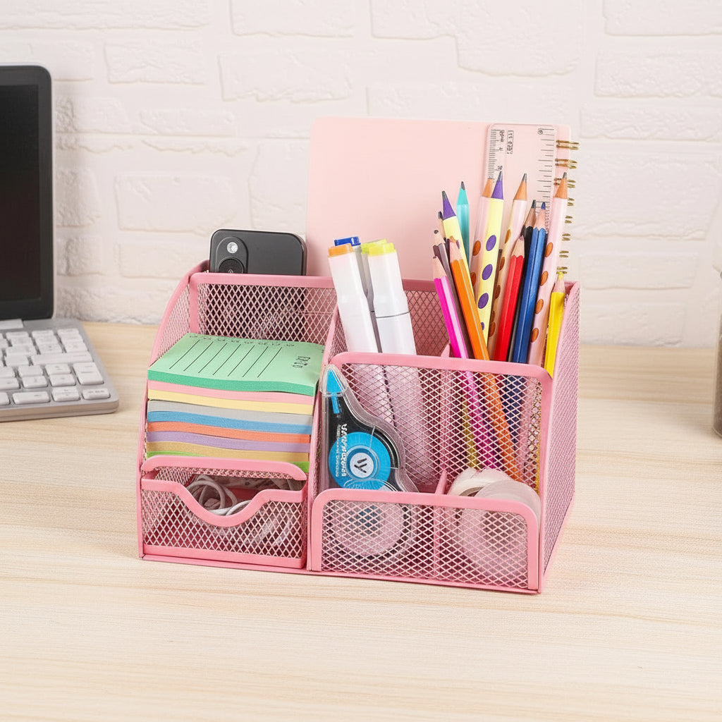 Pink mesh desk organizer with stationery items on a desk.
