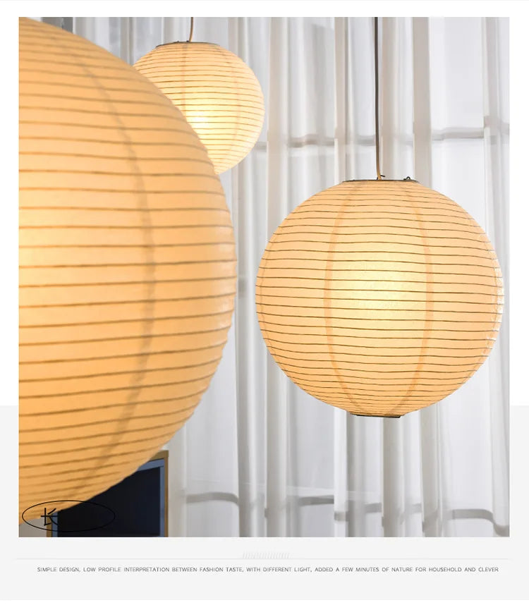 Three round rice paper Japanese lampshades hang from the ceiling.