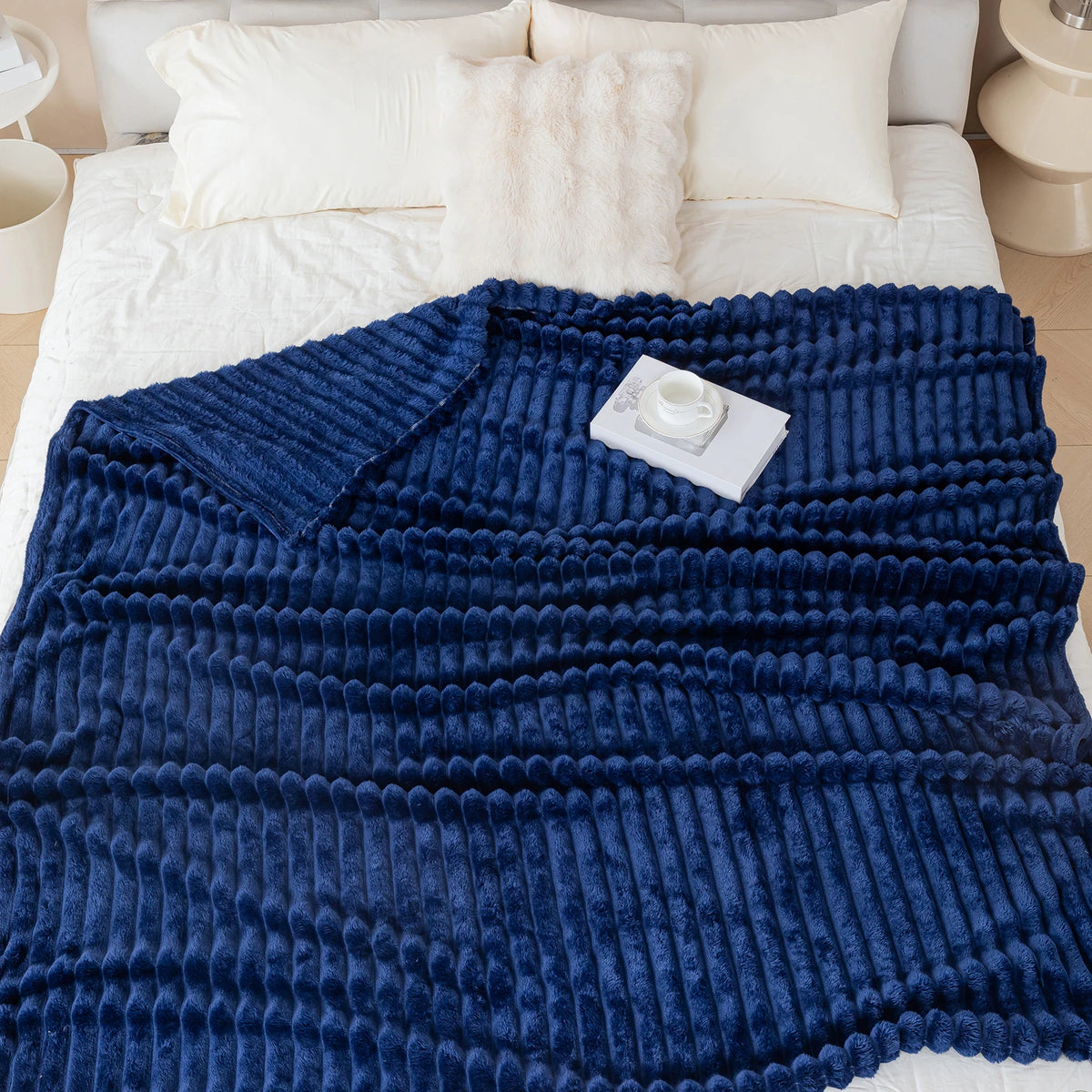 Blue electric blanket on a bed with a control panel, surrounded by pillows and a nightstand.