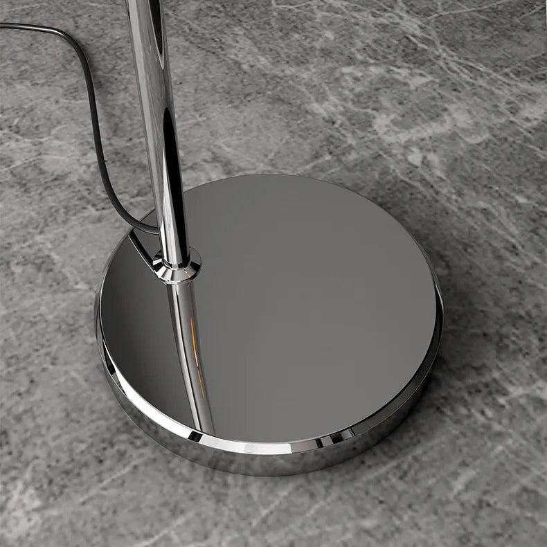 Close-up of the polished round metal base of the adjustable Bauhaus mushroom floor lamp