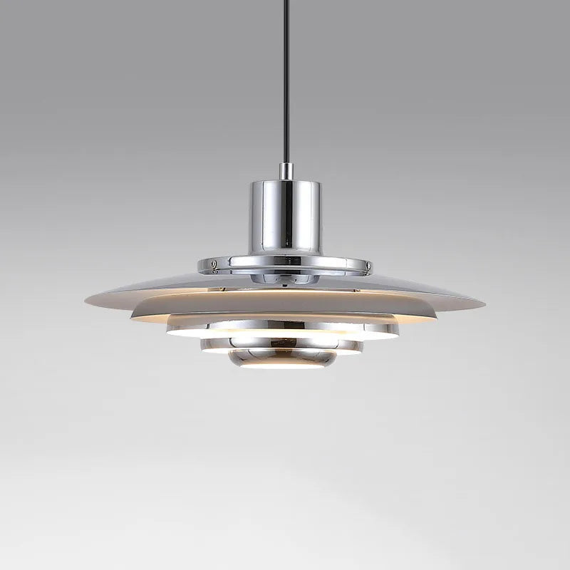 Modern pendant light with a metallic finish on a grey background