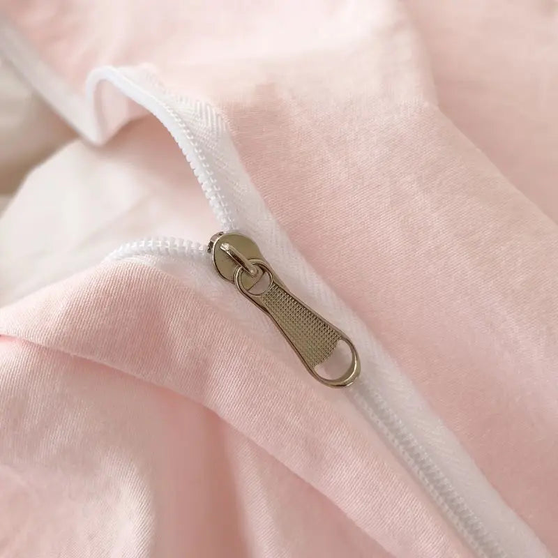 Close-up shot of the high-quality, hidden metal zipper on the Soft Blush pink fabric, demonstrating a seamless and functional design.