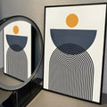 Abstract geometric canvas print with mustard circle and layered black arches on a neutral background