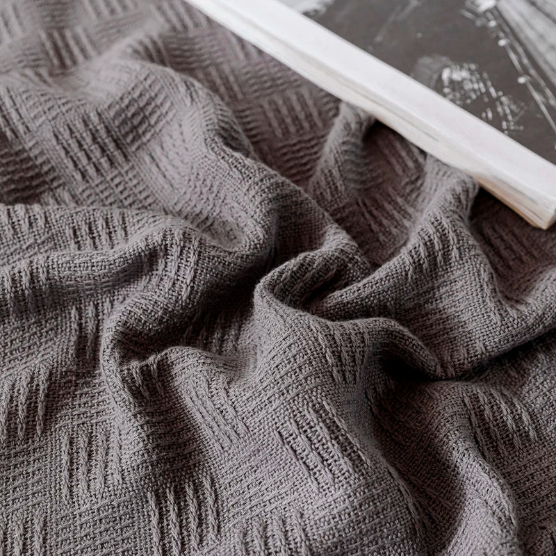 Close-up of textured charcoal grey fabric.