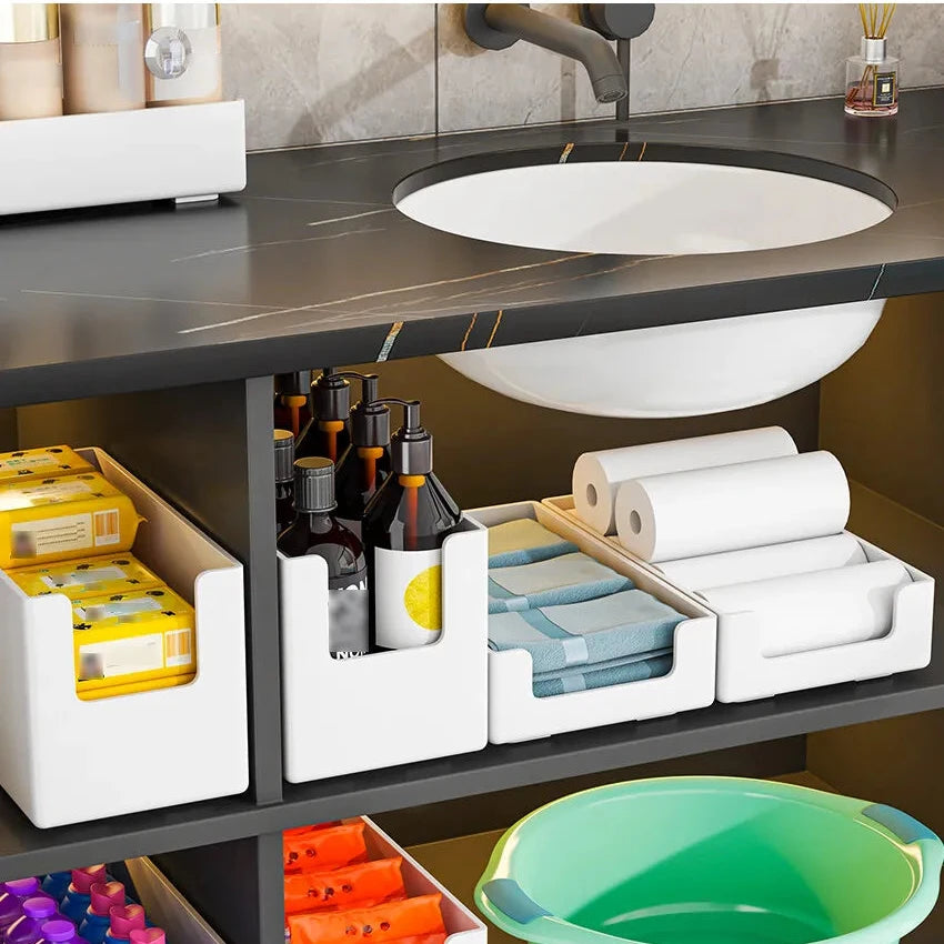 Bathroom counter with storage boxes and a sink, featuring a puzzle storage box.