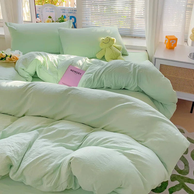 Mint green cotton bedding set with duvet cover, flat sheet, and pillowcases