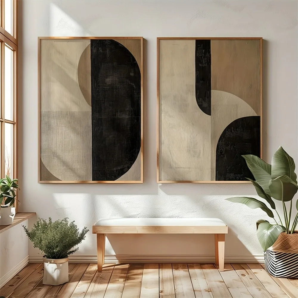 Two abstract neutral wall prints displayed above a wooden bench in a bright, minimalist interior