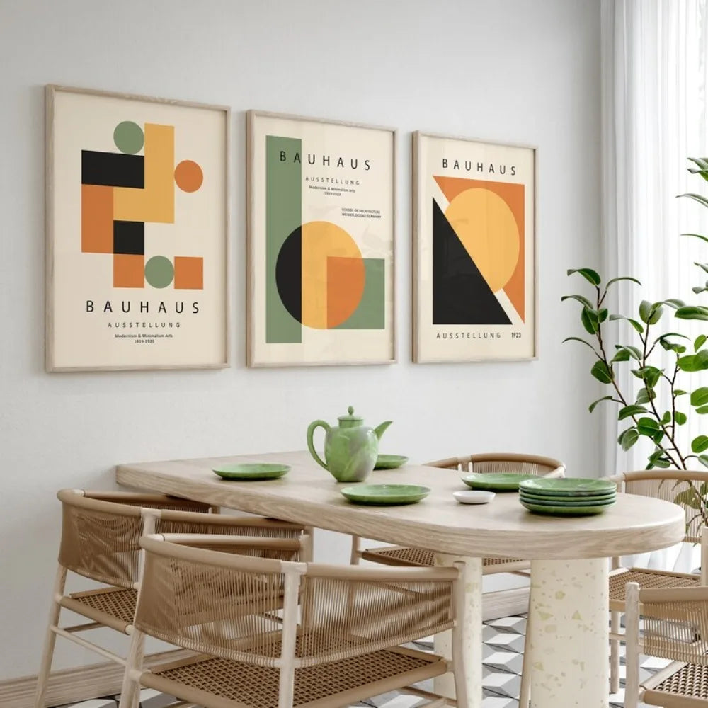 Dining room with a table, chairs, and Bauhaus-style posters on the wall.