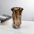Sculptural amber glass vase styled on a modern tabletop
