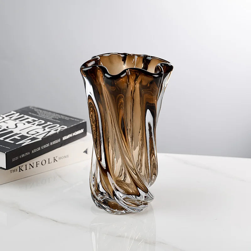 Sculptural amber glass vase styled on a modern tabletop