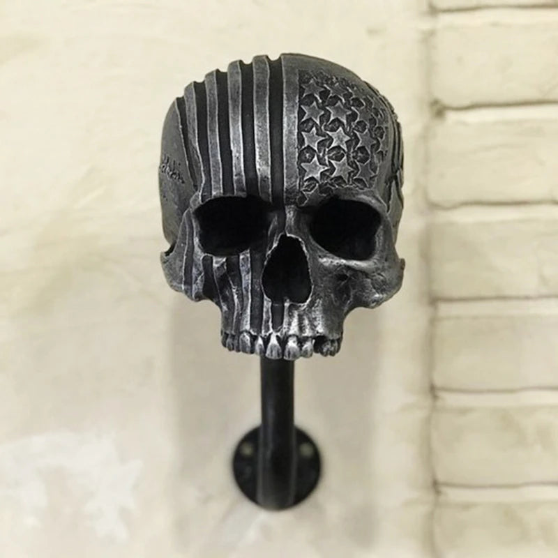 Grey Route 66 skull decorative wall hanger with curved wall hook.