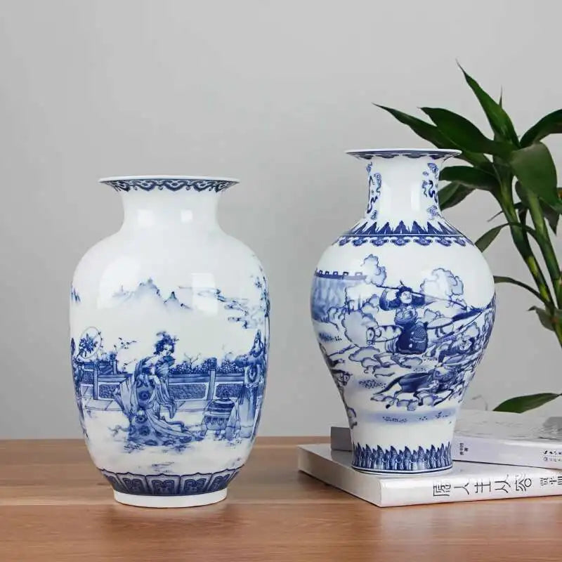 Two blue and white ceramic vases on a wooden surface with a plant in the background.