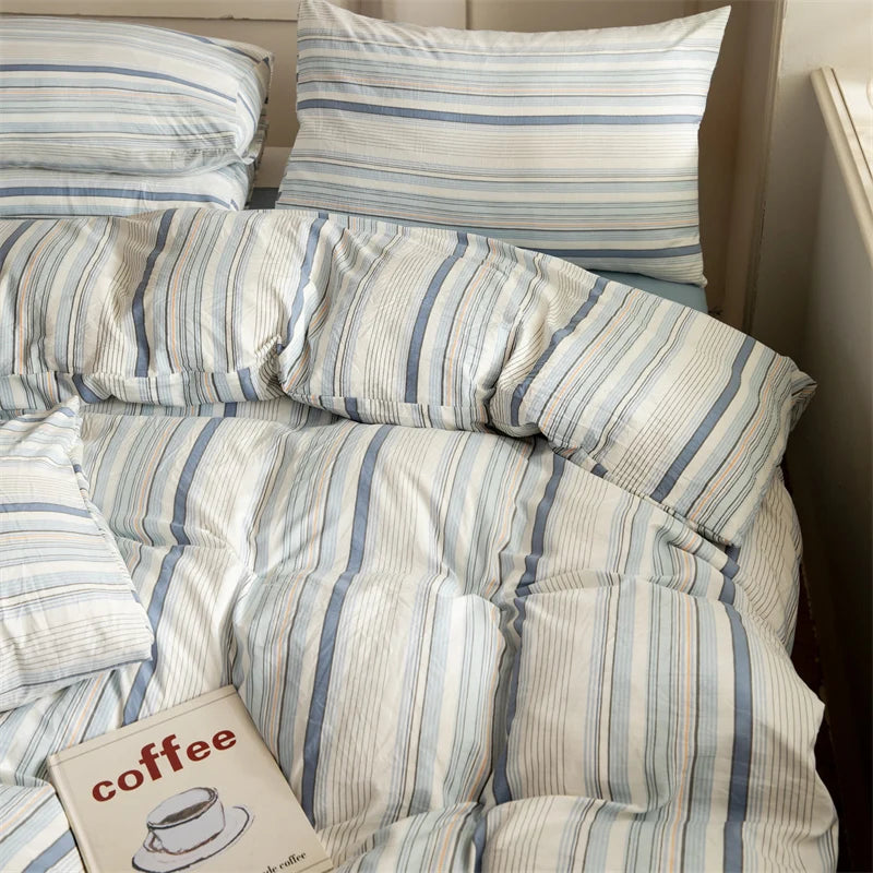 Striped bedding with a 'coffee' book on a bed