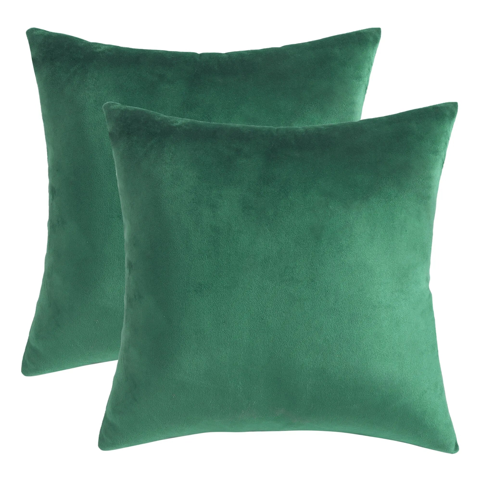 Two green velvet cushion covers on a white background