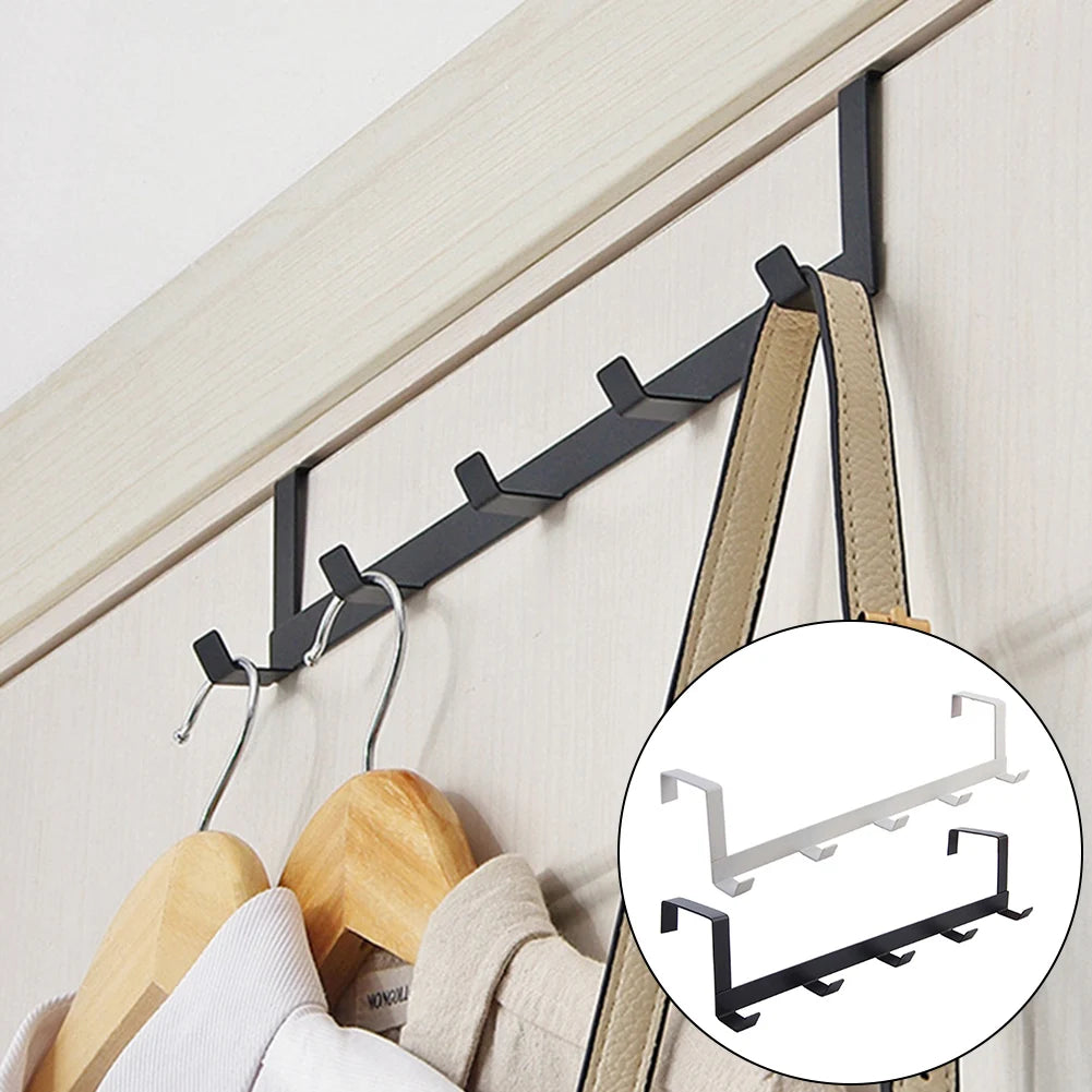 Black over-the-door hook rack used for towels and bathroom accessories