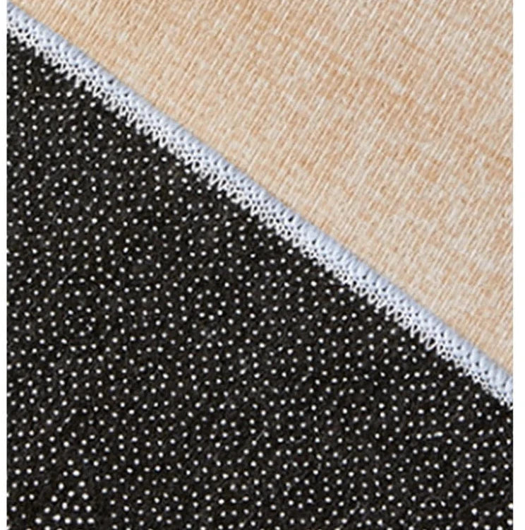 Back view of the rug, black and white Polyester material with a beige border