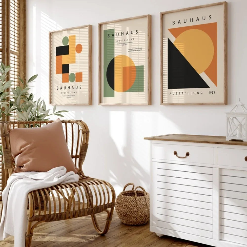 Modern interior with a wicker chair, white cabinet, and Bauhaus-style wall art.