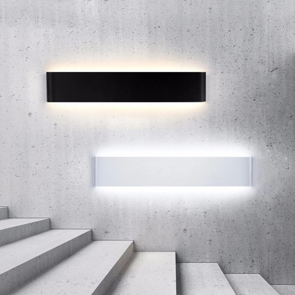 Modern black and white wall lights on a concrete wall with steps below