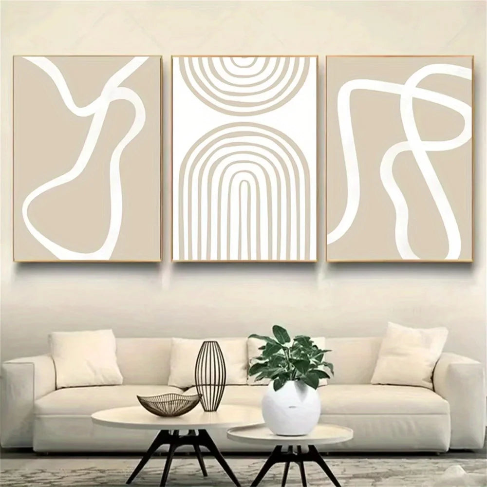 Three abstract line art canvases displayed above a beige sofa in a modern living room.