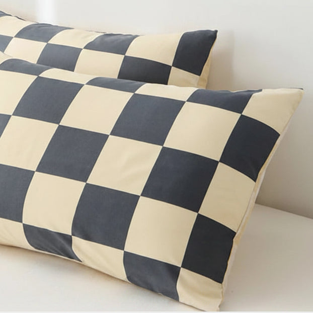 Checkered pillowcases on a bed with envelope closure design explanation.