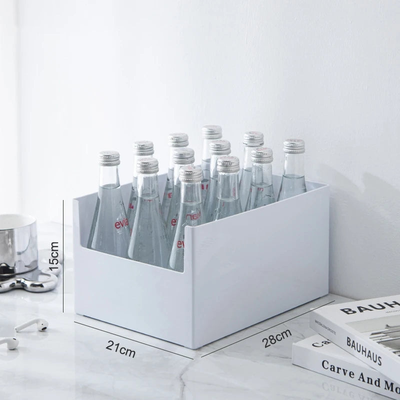 White bottle holder with Evian bottles on a white surface with books in the background