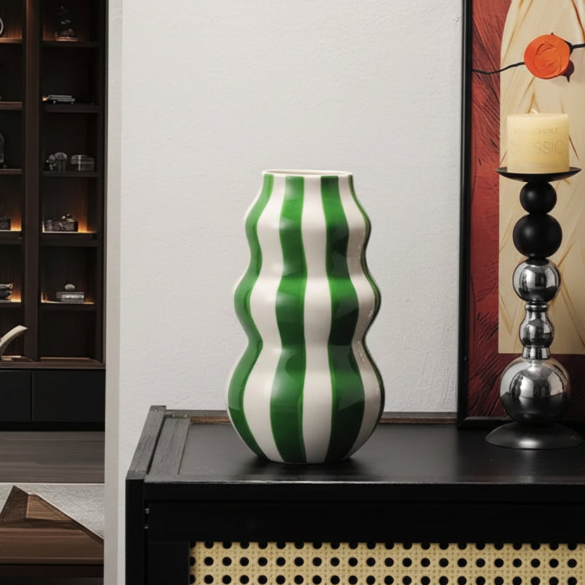 Green and white striped vase on a table with dimensions displayed