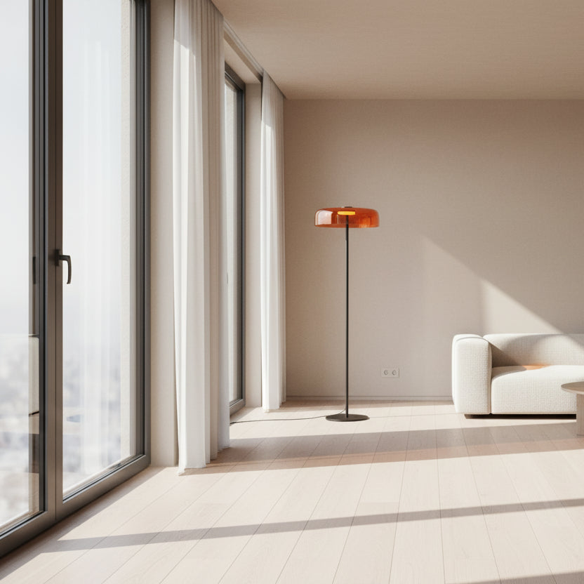 Contemporary floor light with a sunset amber glass shade and sleek gold frame for aesthetic home interiors.