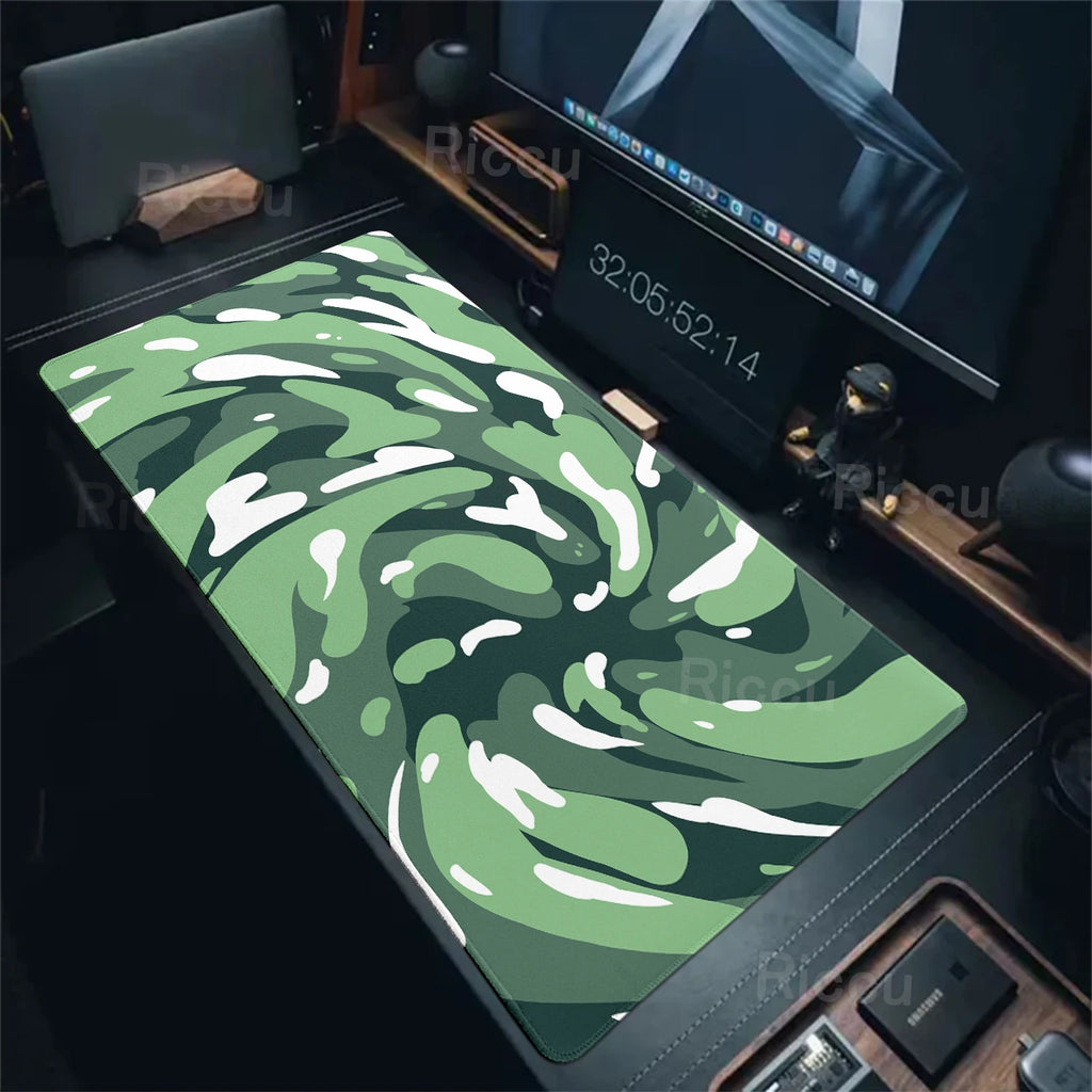Camouflage desk mat on a desk with computer equipment