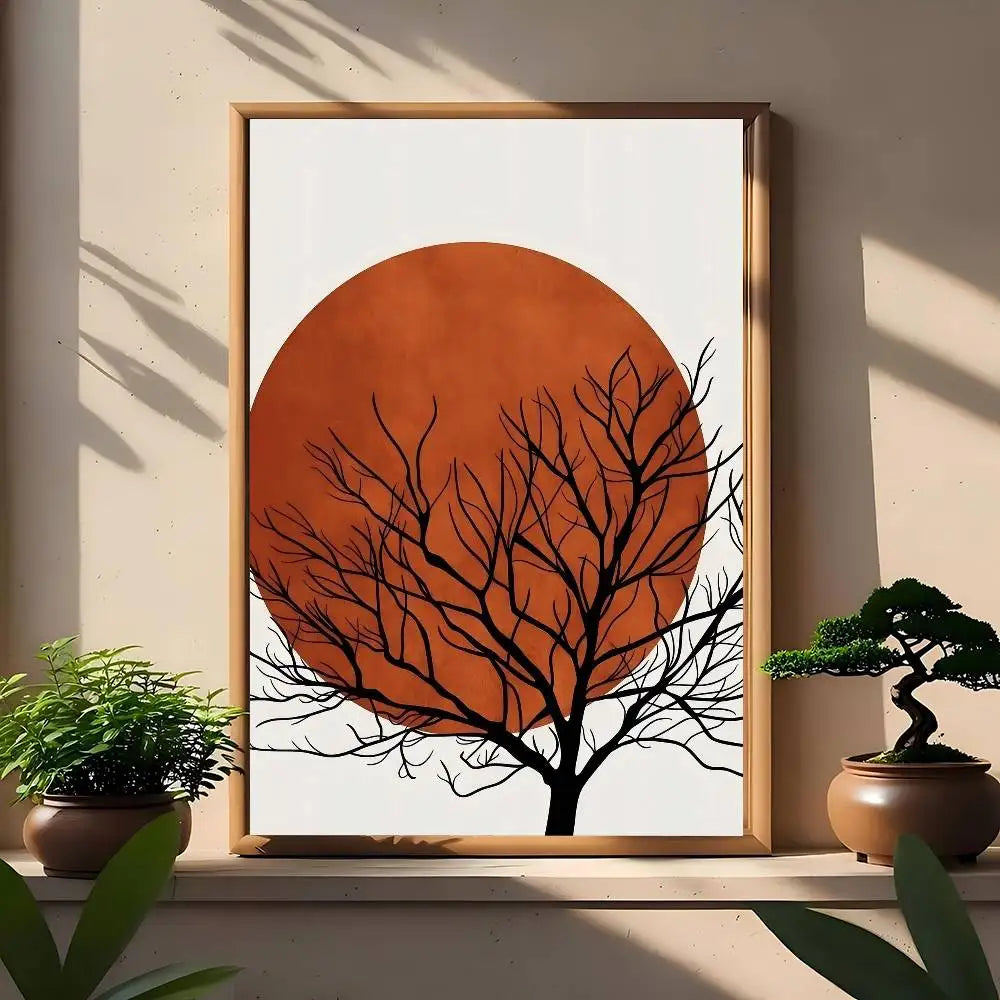 Minimal canvas print with large burnt-orange sun and black bare tree branches stretching across the circle.