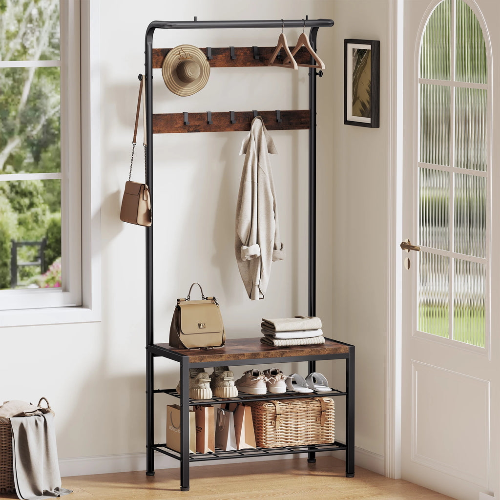Hall tree styled in a home entryway with coats, bags, and shoes