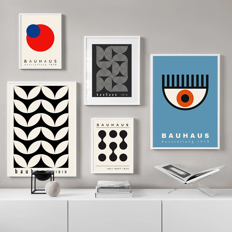 Collection of Bauhaus-themed posters on a wall with a gray background.