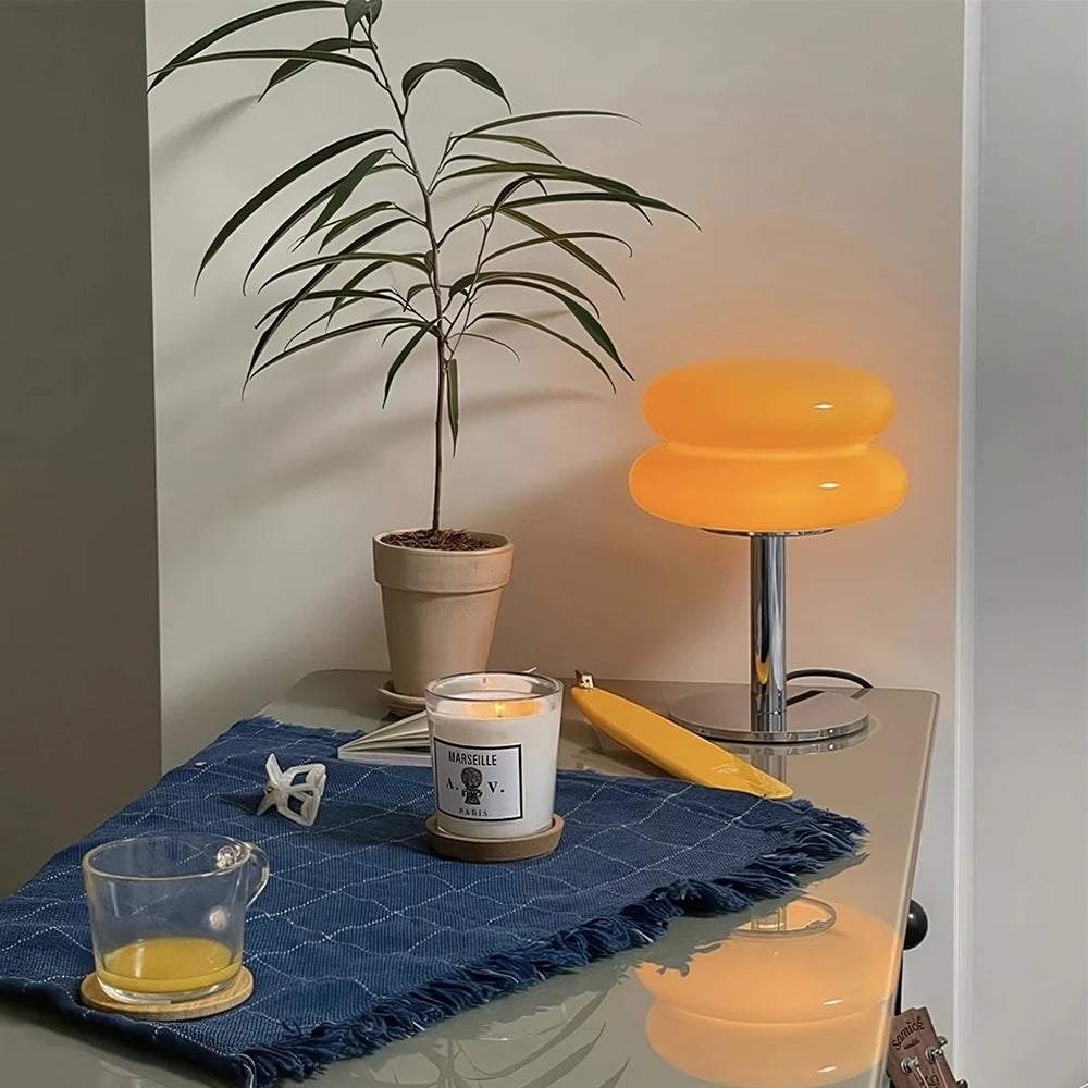 An orange table lamp in a room setting