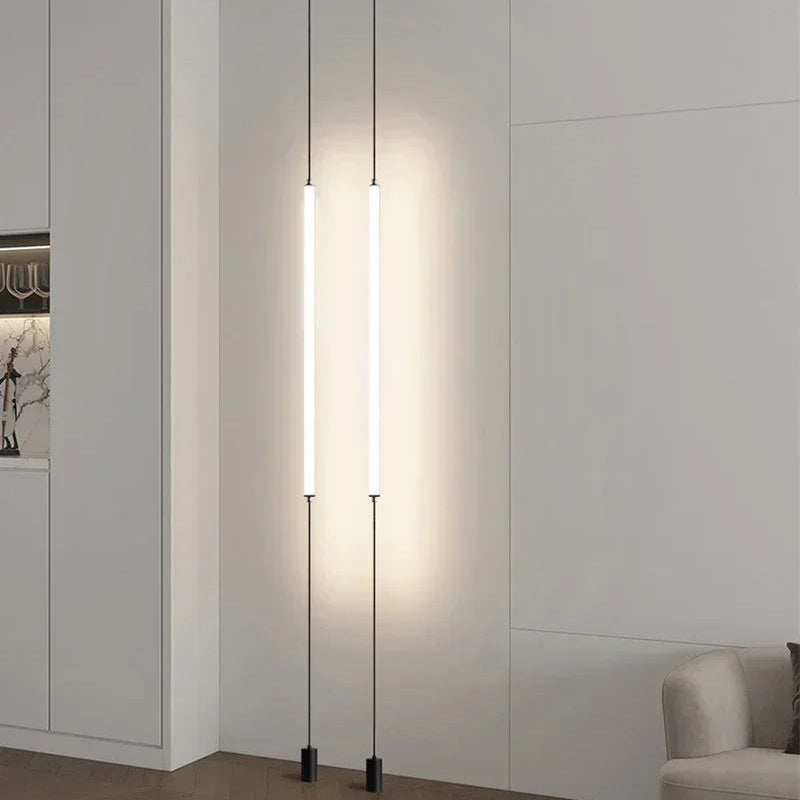 Dual slim Italian floor lamps mounted in a contemporary white living space