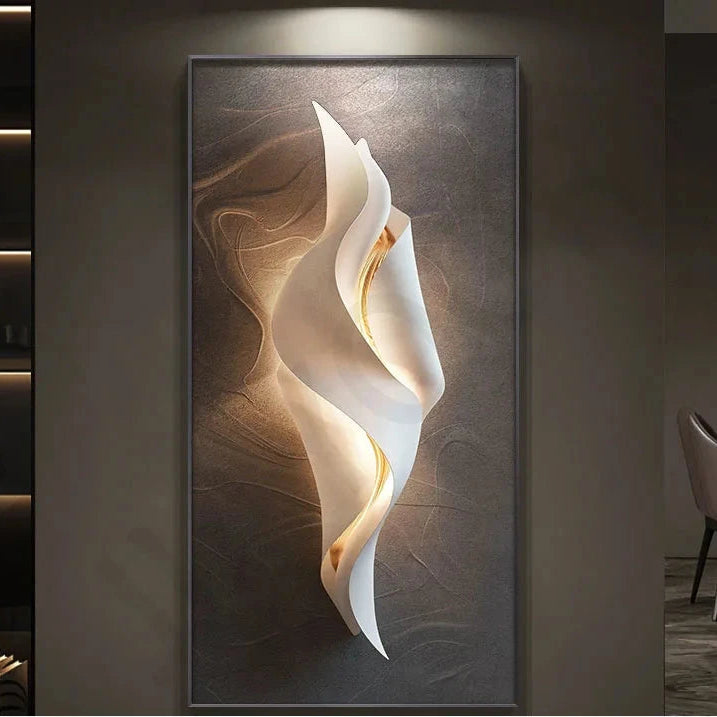 Lumina Flow LED wall art light with compact twisted white ribbon design and warm gold glow on a brown textured canvas