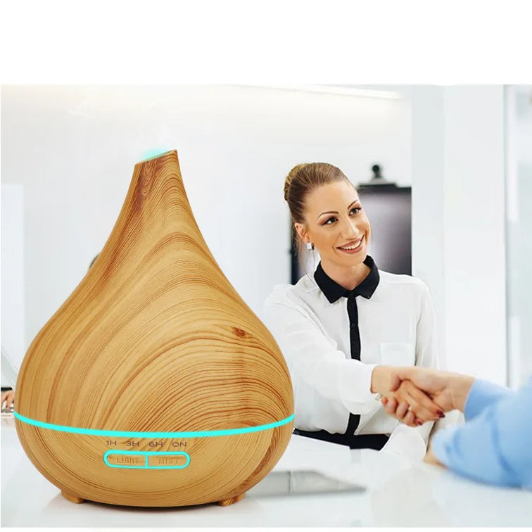 Wooden diffuser on a desk with two people shaking hands in the background