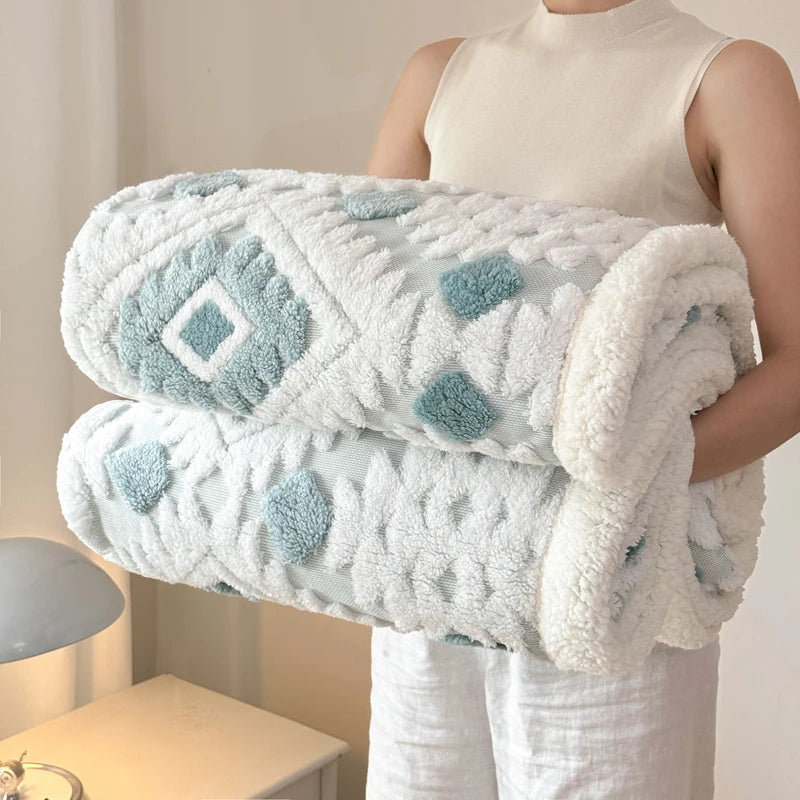 Olive green and ivory textured blanket displayed on a cream bedroom bed.