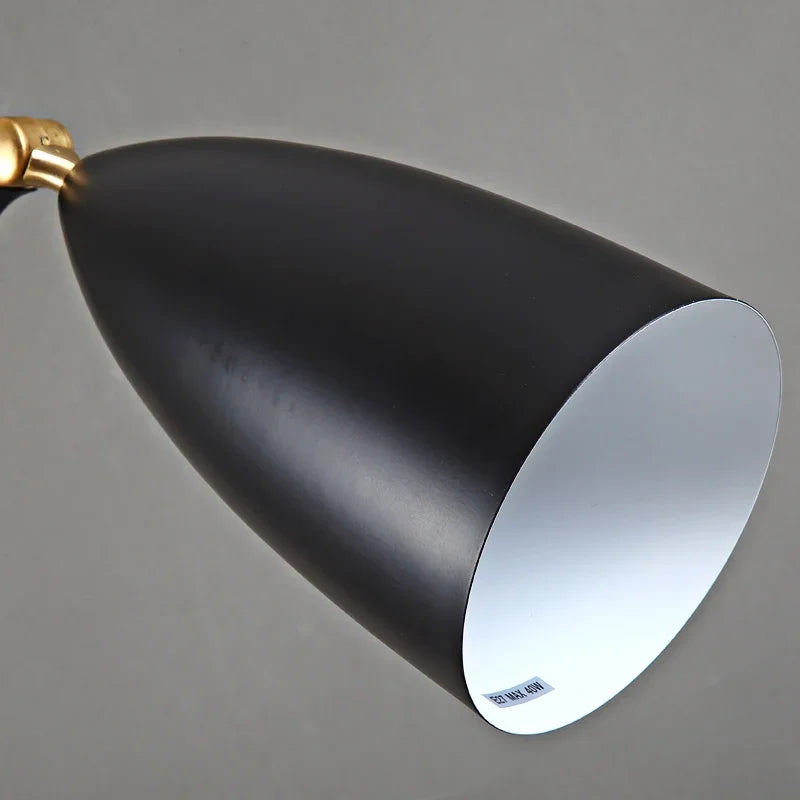 Black cone-shaped lampshade with gold accent on a grey background
