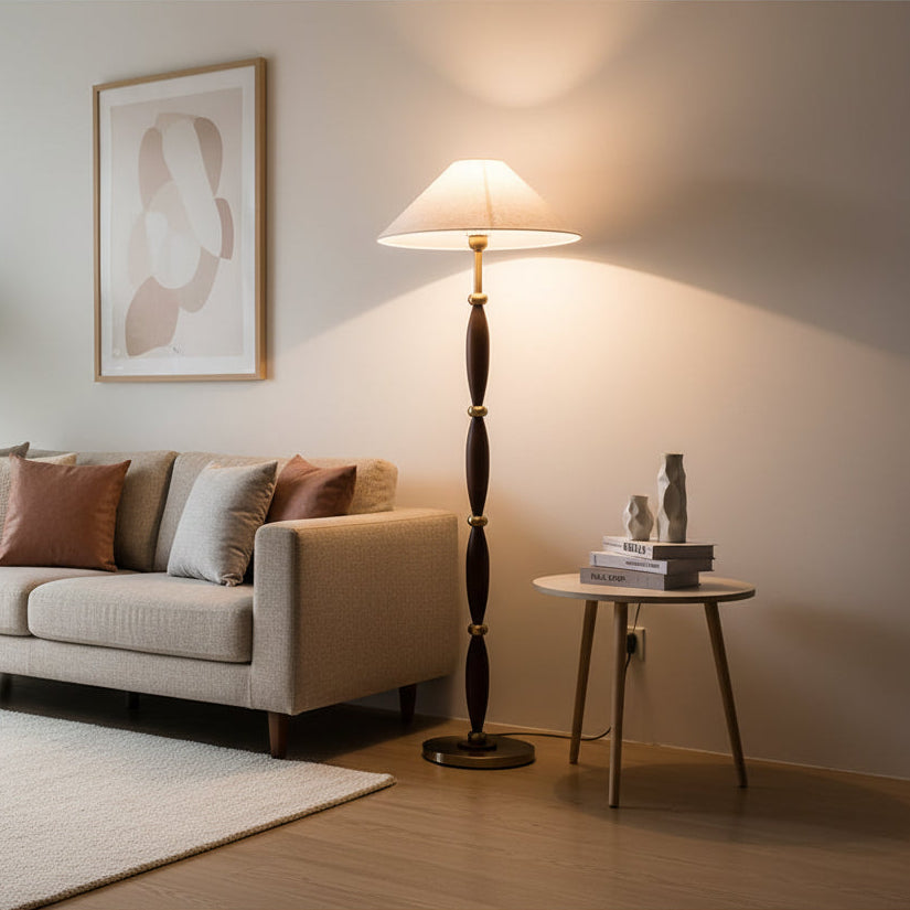 Living room with a beige sofa, floor lamp, and side table.