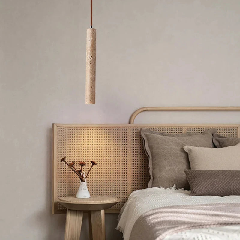 Bedroom with wooden headboard, pendant light, and side table.