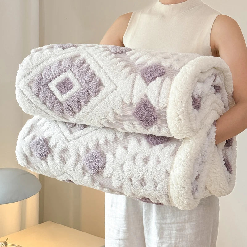 Person holding a Lavender textured blankets with geometric patterns.
