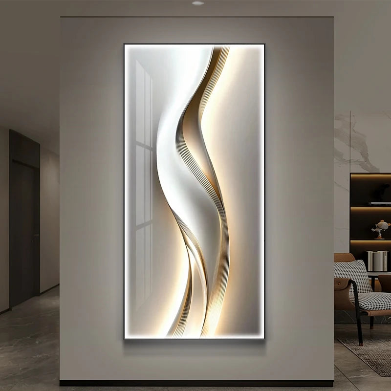 Gold and silver ribbon wave LED backlit wall panel glowing on a grey wall