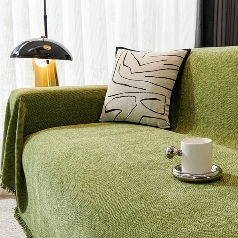 Moss Green 350gsm chenille furniture protector on a sofa in a brightly lit room.