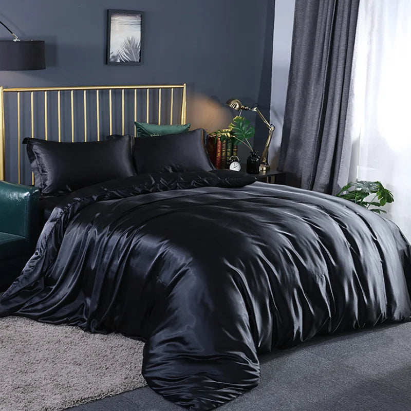 Midnight Black satin bedding set on a bed in a bedroom with grey walls and decor.