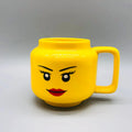Yellow mug designed like a character with a womens facial features on a grey background
