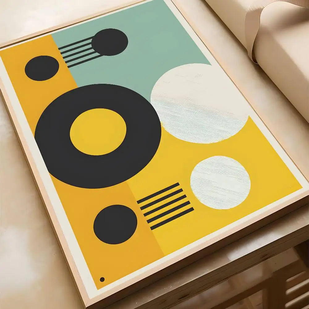 Bold abstract canvas print featuring dark circles, a large yellow ring, and textured white circles on a vibrant yellow and teal background, in a wood frame.