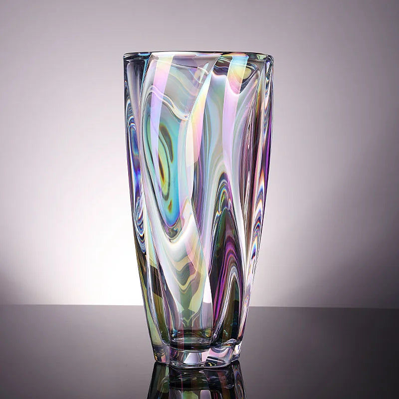 Iridescent pearl crystal vase showing rainbow light reflections and a twisted silhouette.