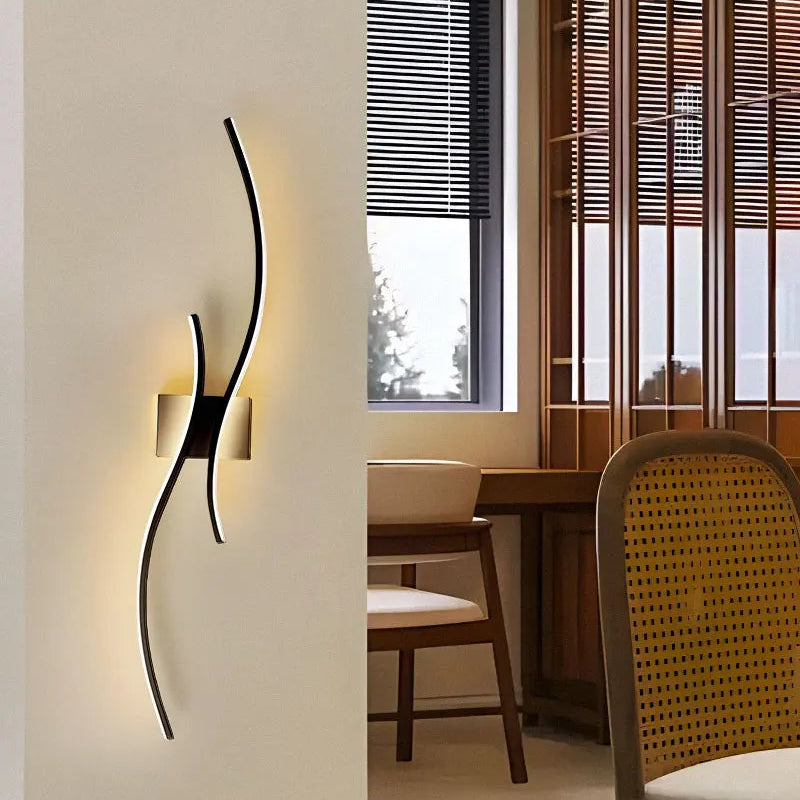 Modern black wall sconce in a dining room setting with chairs and a window.