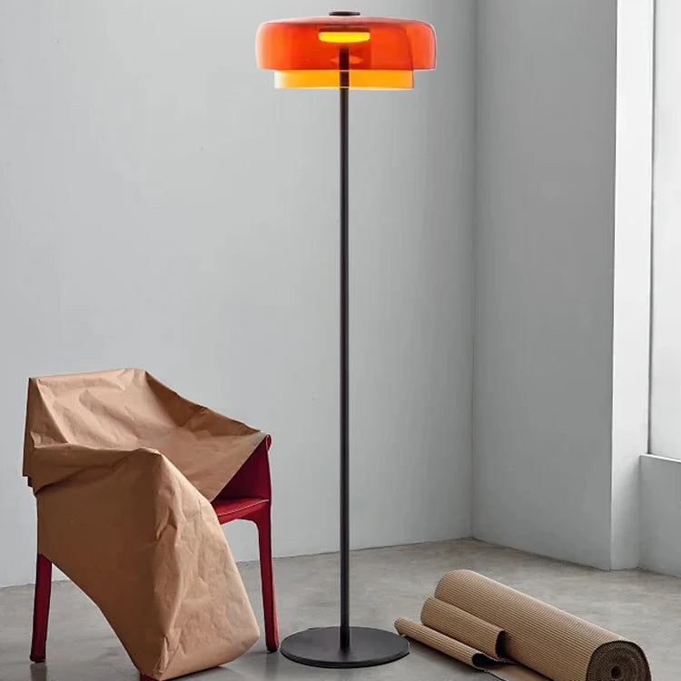 Contemporary floor light with a sunset amber glass shade and sleek gold frame for aesthetic home interiors.